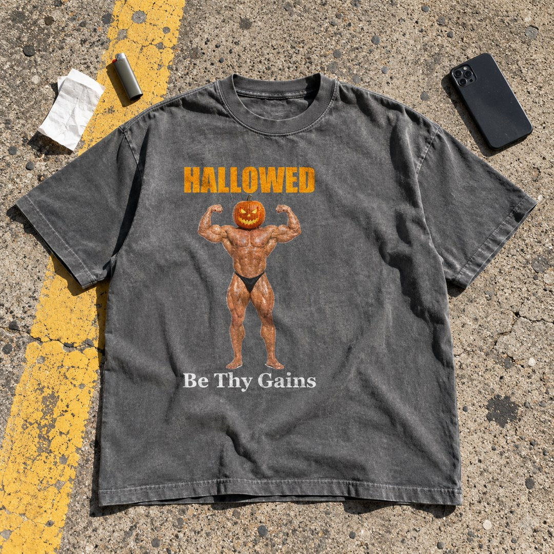 Hallowed Be Thy Gains Shirt laid flat in a parking lot