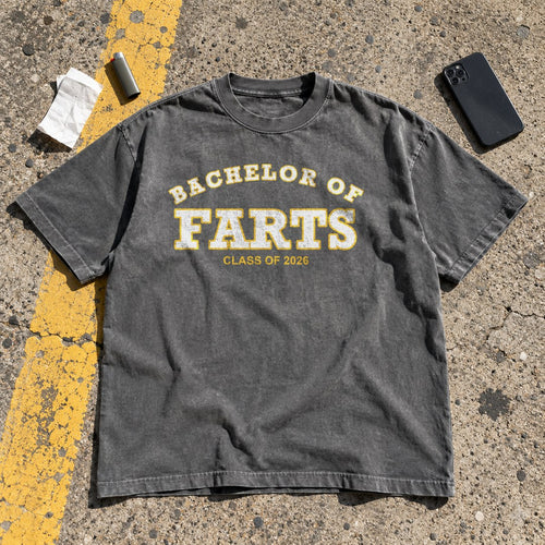 Bachelor of Farts Shirt laid flat in a parking lot