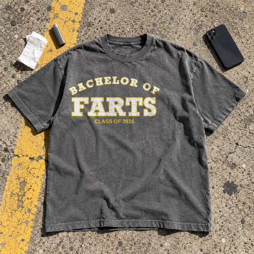 Bachelor of Farts Shirt laid flat in a parking lot