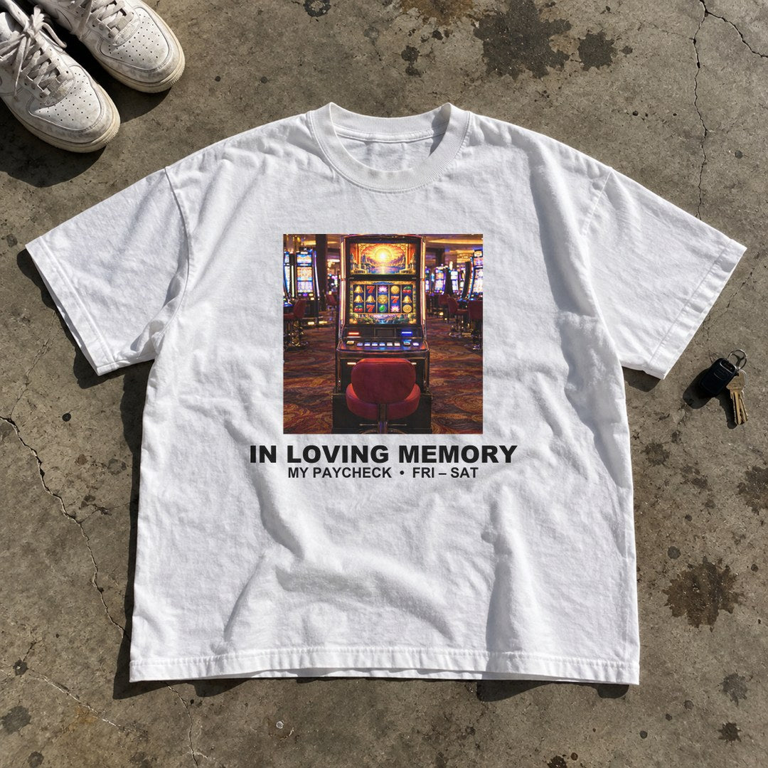 In Loving Memory of My Paycheck Shirt laid flat on a concrete garage floor