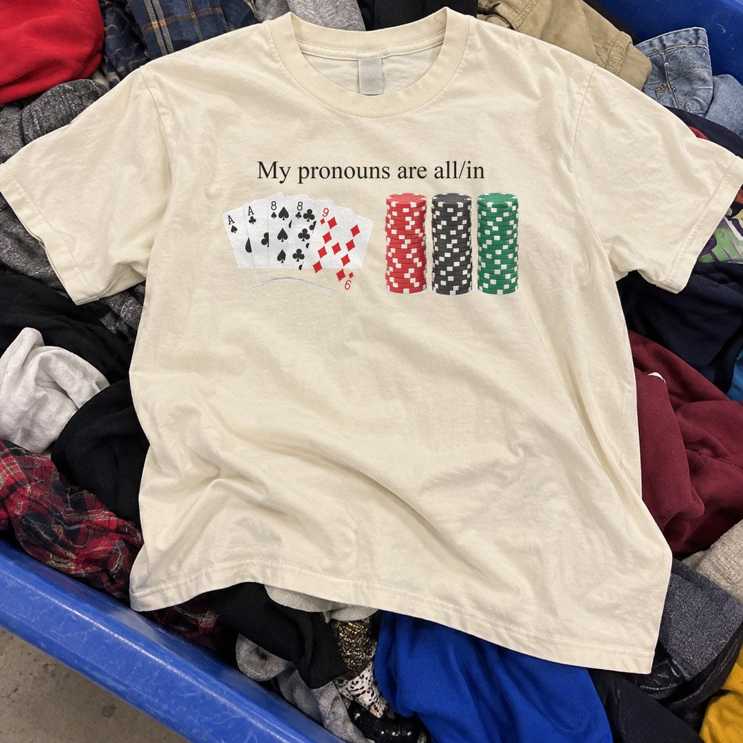 My Pronouns Are All In Shirt found in a thrift store bin