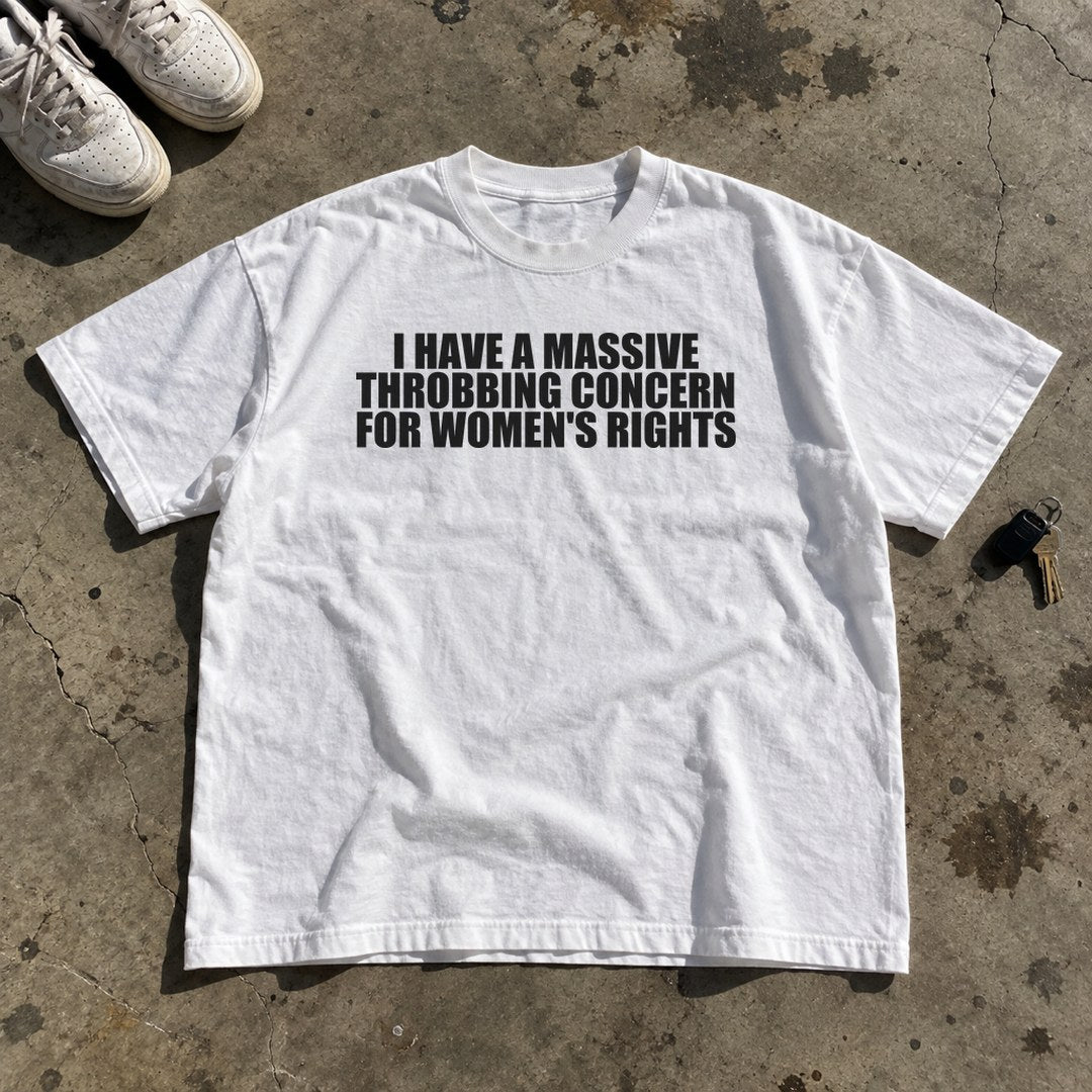 Massive Throbbing Concern for Women's Rights Shirt laid flat on a concrete garage floor