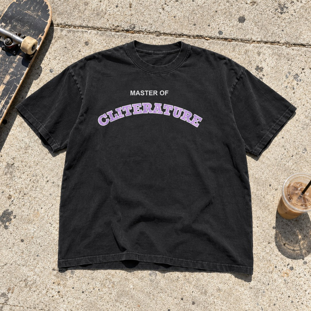 Master of Cliterature Shirt laid flat on a city sidewalk