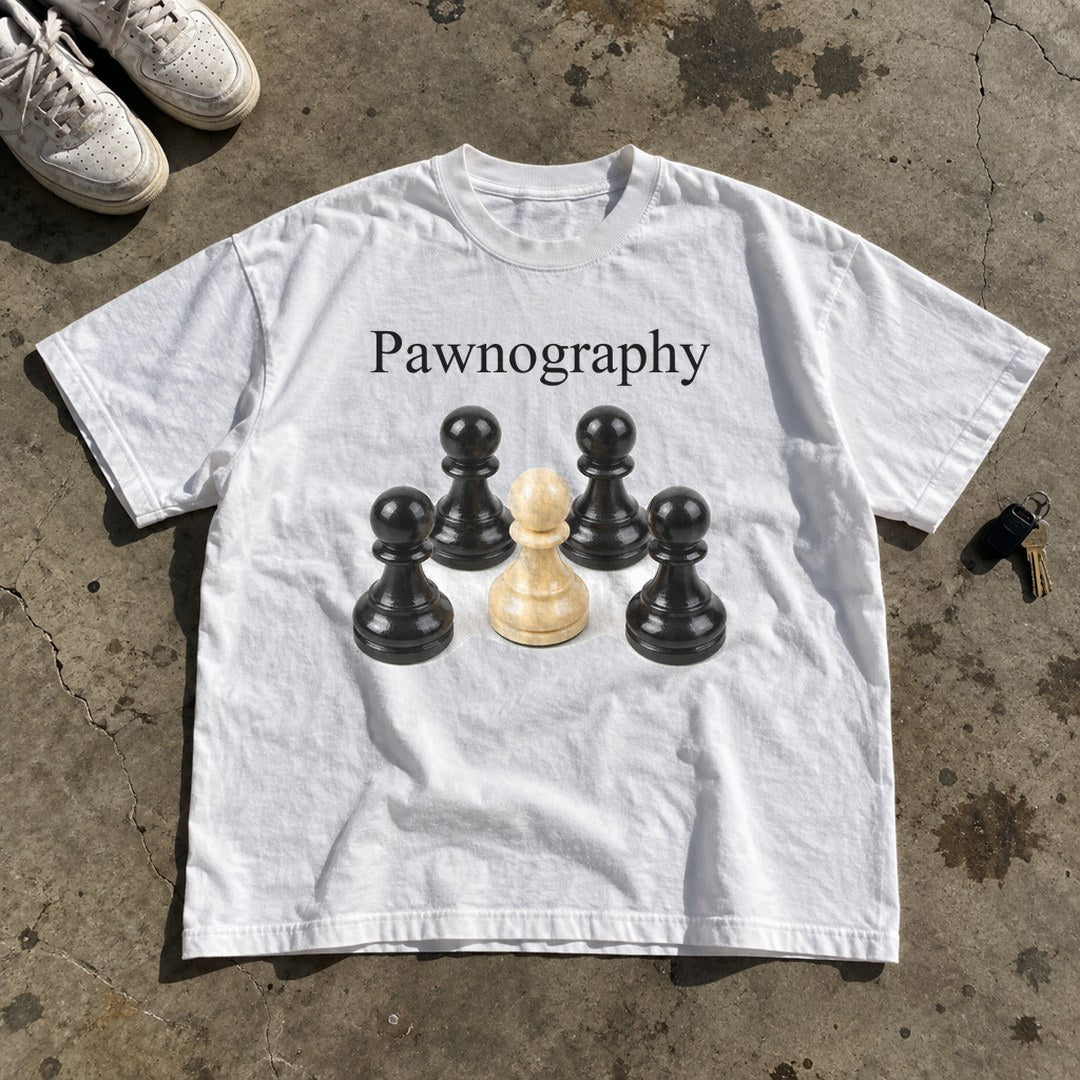 Pawnography Shirt laid flat on a concrete garage floor