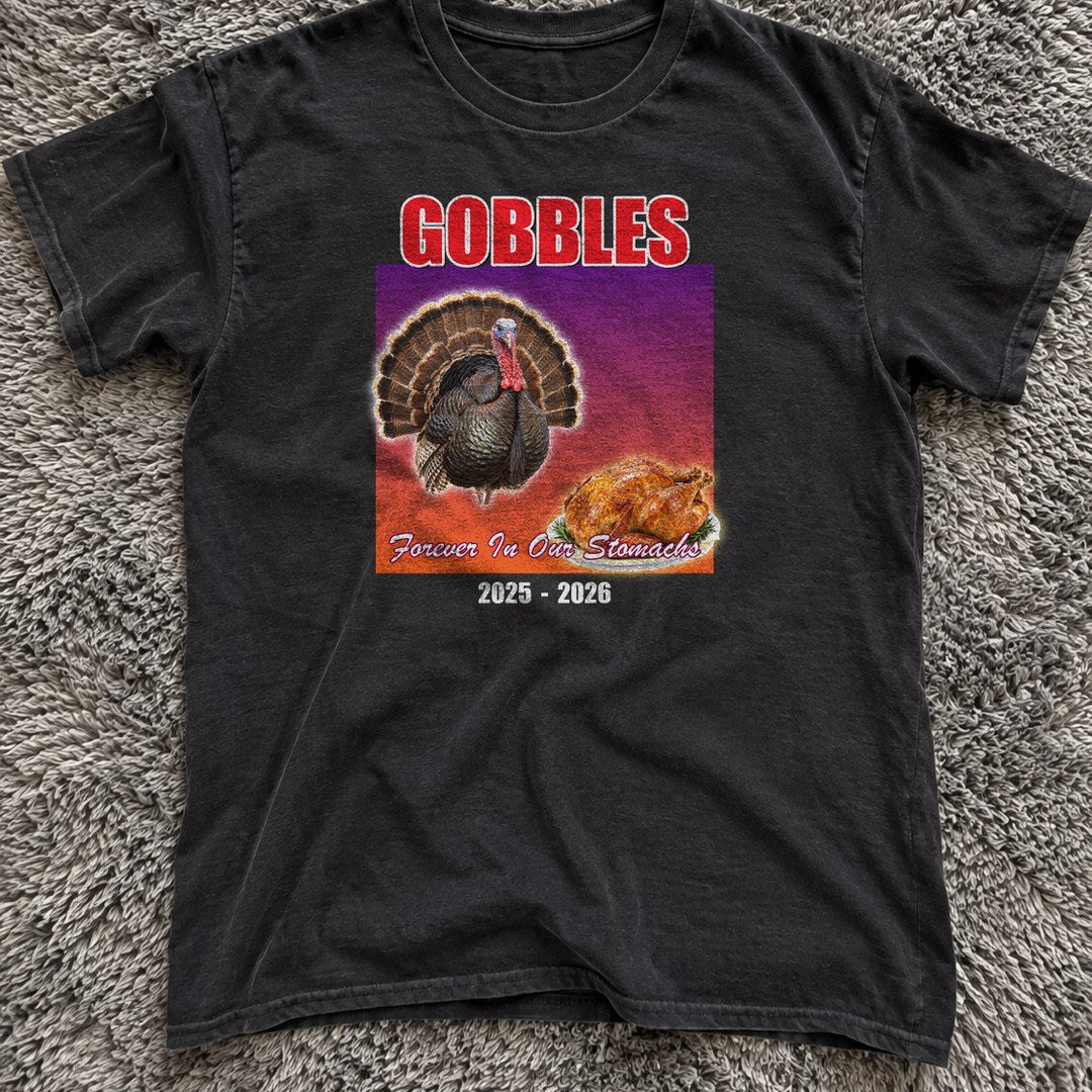 Gobbles Forever in Our Stomachs Shirt on a grey rug