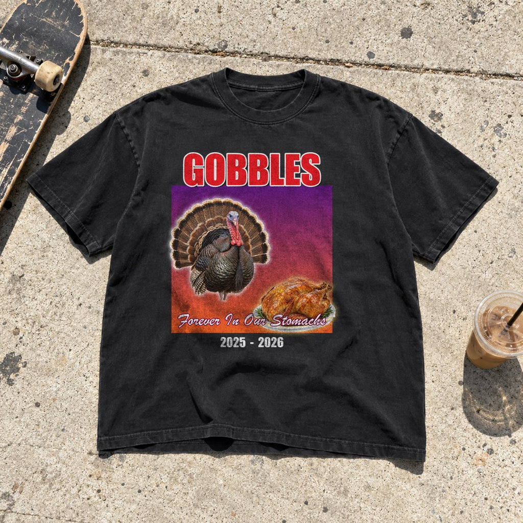 Gobbles Forever in Our Stomachs Shirt laid flat on a sidewalk