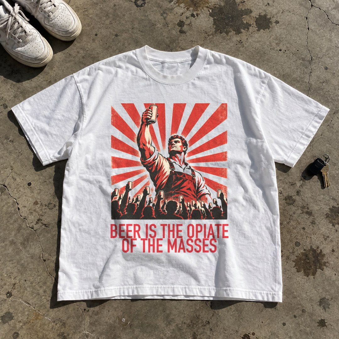 Beer Is the Opiate of the Masses Shirt laid flat on a concrete garage floor